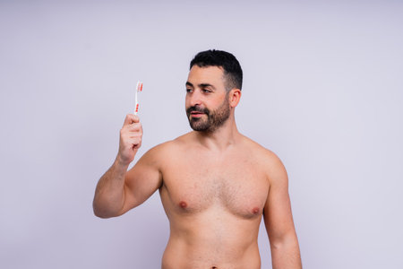 Brush teeth everyday. Masculine model happy to care of oral hygiene, toothbrush, Sanitary conceptの写真素材
