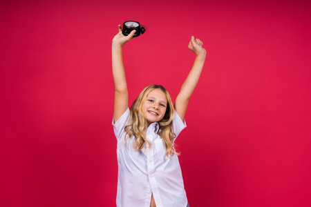 Young Girl holding an antique clock over red background