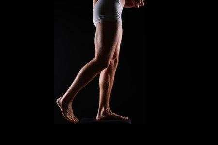 Close-Up of Bodybuilders Legs Ready For Competitive Sport white pantiesの写真素材