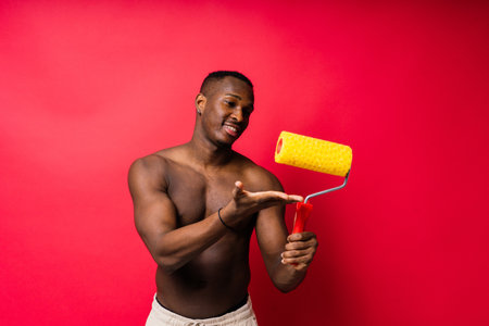 African-American painter on red studio background toplessの写真素材