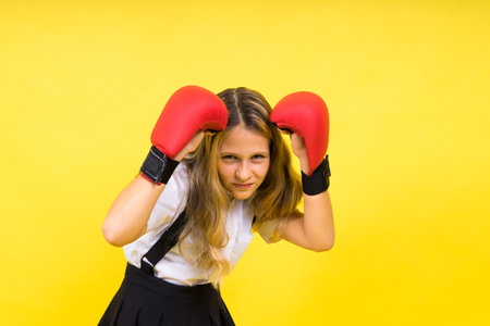 Little girl wearing red boxing gloves, studio shot, sport conceptの写真素材