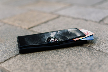 The wallet with coins on sidewalk street, forgotten money
