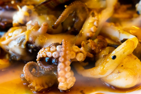 Grilled octopus closeup with another seafood with herbs and spices. Top viewの写真素材