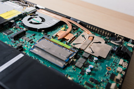 Prague, Czechia - 7th May 2022 Service engineer install new chips to laptop. Repairing laptop.