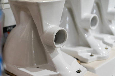 Showcase with toilets. Sale in the plumbing store of toilet bowls of different models.