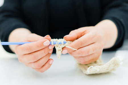 Process of knitting isolated on white, female hands