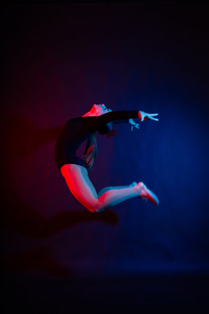 High jump, flight. Little flexible girl, rhythmic gymnastics artist jumping. Grace motion, action.