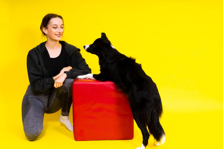 Woman walking and getting exercise for both herself and her border collie dog.の写真素材