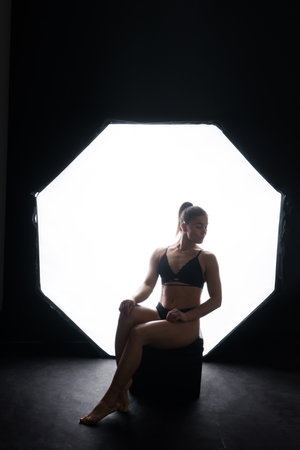 Female silhouette in lingerie. Young slim seductive woman with sport fitness bodyの写真素材
