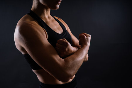 Portrait of a female mixed martial arts fighter with a bandage and gloves on her hands.の写真素材