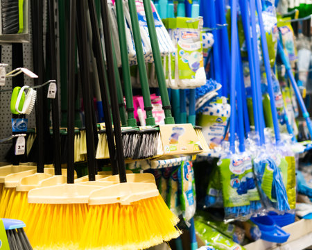 Plastic brushes for cleaning premises. Assortment of multi-colored brooms in the store. Close-upの写真素材