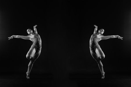 Dancing flying girl, jumping in studio shooting, sport and danceの写真素材