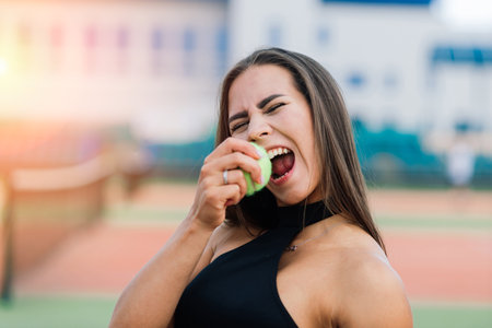 Beautiful stylish sexy woman in trendy sportswear on tennis court.の写真素材