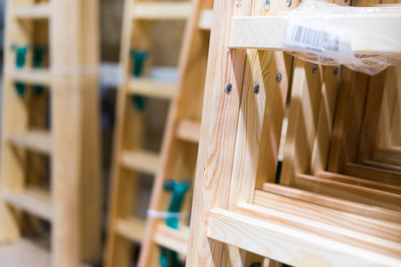 Many Wooden ladders. Stack of wooden stairs in a store.