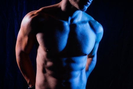 Beautiful male torso, muscular bodybuilder posing. Seductive portrait of sport man.の写真素材