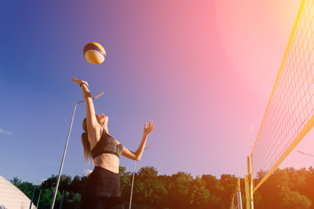 A female beach volleyball athlete on the volleyball courtの写真素材
