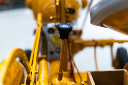 Small yellow tractor in exhibition, closeup details, wheels