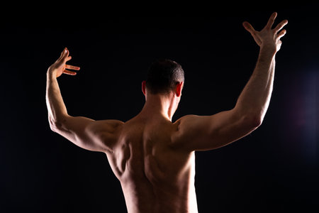 Portrait of man, bodybuilder and bicep flex in a studio, background and exercise for muscular power.の写真素材