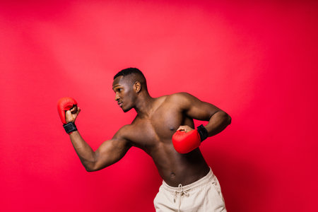 Young African American male boxer with a bare torso, muscular body. Concept of trainingの写真素材