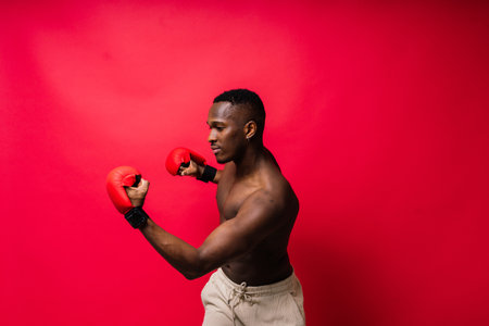Young African American male boxer with a bare torso, muscular body. Concept of trainingの写真素材
