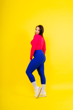 Active plus-size woman in a sport top and leggings. Fitness, body positive, emotions.の写真素材
