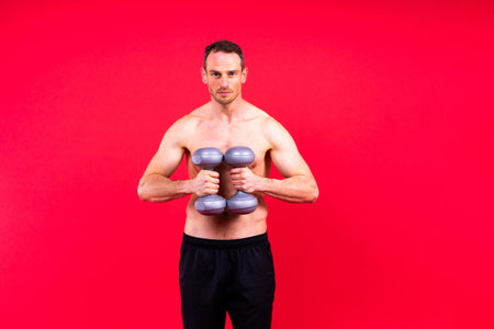 Young man working out on a studio background.の写真素材