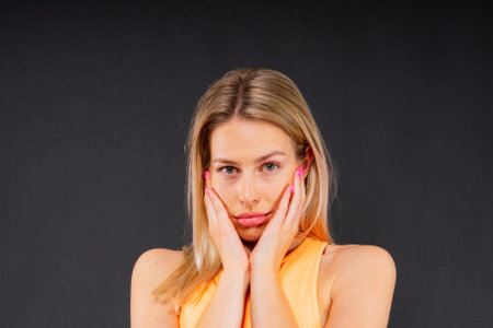 Portrait, fitness or body of young woman in studio isolated on yellow black red background.の写真素材