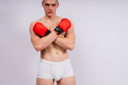 Studio shot of athlete boxer training and practicing a jab. Isolated on white studio background.の写真素材