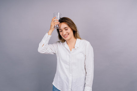 Beautiful model portrait isolated over a studio background hold glass.の写真素材