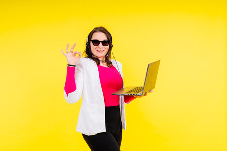 Young plus size woman hold a laptop pc computer. Body positive conceptの写真素材