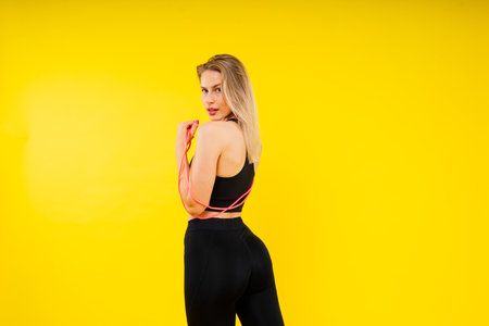 Fitness and sport concept. Portrait of a smiling young woman wearing sportswear posing isolatedの写真素材