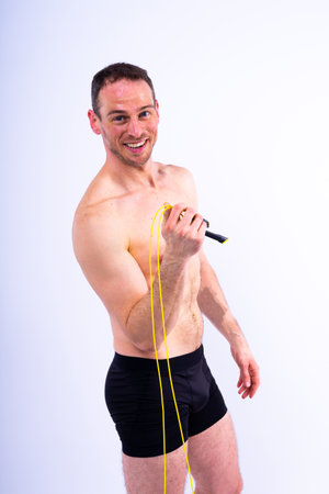 Portrait, happy man and bodybuilder with abs on a studio background, backdrop and topless prideの写真素材