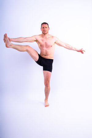 Portrait, happy man and bodybuilder with abs on a studio background, backdrop and toplessの写真素材