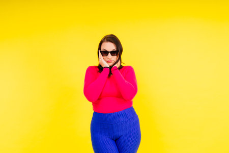 Full length photo of a young smiling woman wearing sportswearの写真素材