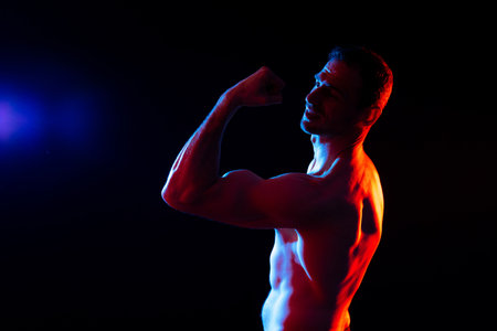 Portrait, happy man and bodybuilder with abs on studio background, backdrop and topless prideの写真素材