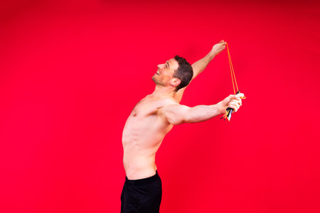 Portrait, happy man and bodybuilder with abs on studio background, backdrop and topless prideの写真素材