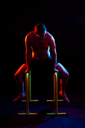 Portrait, happy man and bodybuilder with abs on studio background, backdrop and topless prideの写真素材