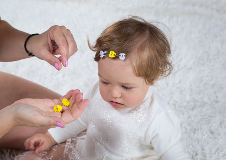 Mom makes hairstyle of his daughterの写真素材