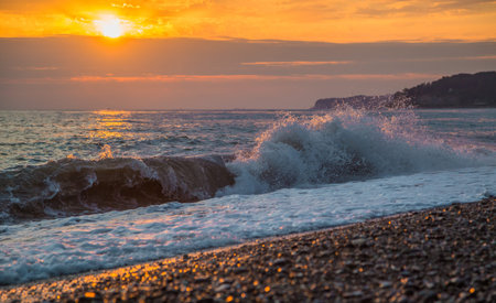 The surging waves on the beach at sunsetの写真素材