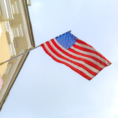 American flag flies on the building of the old hotel in the tourist city in Russia