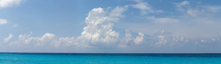 Panoramic view of beautiful white clouds, blue sky and turquoise sea as a template, background or backdropの写真素材