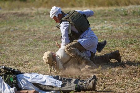 SAMBEK, ROSTOV REGION, RUSSIA, AUGUST 19, 2018: Reconstruction of Afghan war. Hand-to-hand fight between a Soviet soldier and a mujahidのeditorial素材