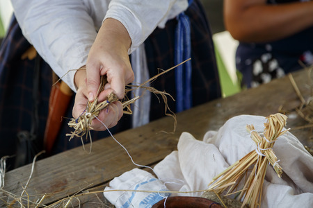 Woman shows how to make a strawberry Traditional Russian folk artの写真素材