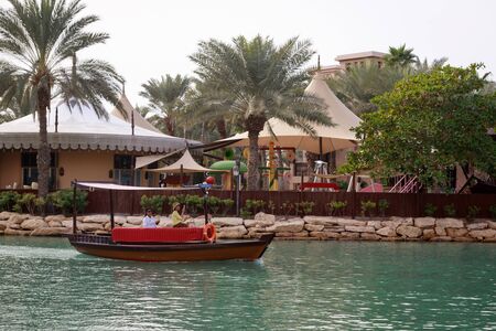 DUBAI, UAE, JANUARY 13, 2019: A traditional wooden boat with tourists in Madinat Jumeirahのeditorial素材