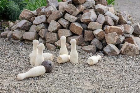 White skittles and a heavy iron ball as props for bowling on an unequipped area.の写真素材