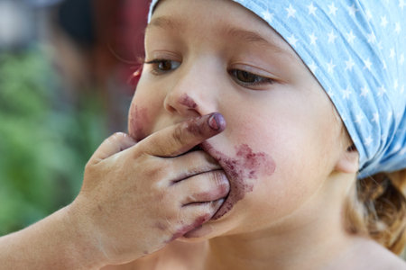 Little girl eating mulberry berries