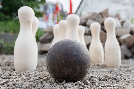 Ancient metal ball on the background of standing white pins.の写真素材