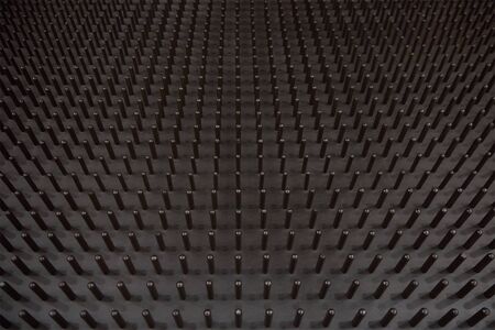 Metal mold with pins forming the surface of a latex mattressの写真素材