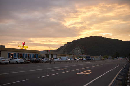 Lermontovo, Krasnodar Region, Russia, July 25, 2019: View of the highway passing through the city against a beautiful orange sunsetのeditorial素材