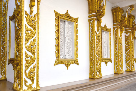Building wall with windows decorated with oriental gold patterns.
